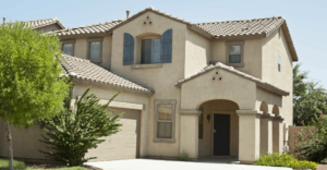 Residential home exterior in Phoenix showing potential damage signs of the roof requiring inspection
