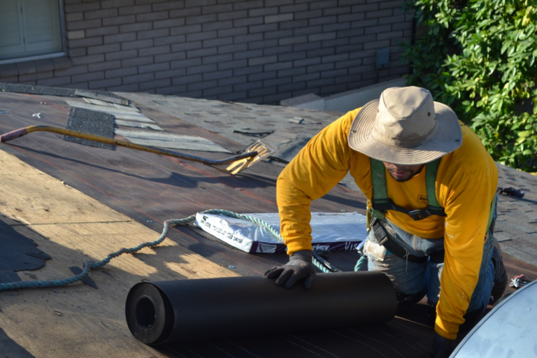Roofing professional working on tile roof repair before solar panel reinstallation in Arizona