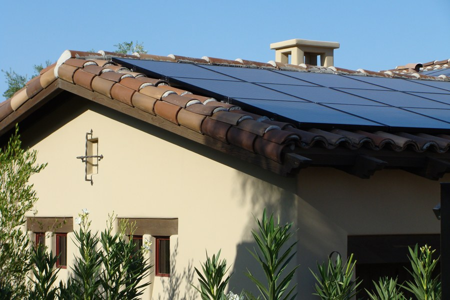 Solar Attic Fans in Phoenix, AZ vs. Standard Attic Ventilation: What Actually Works in Arizona Arizona tile roof with solar panels showing how ventilation and solar planning support roof performance
