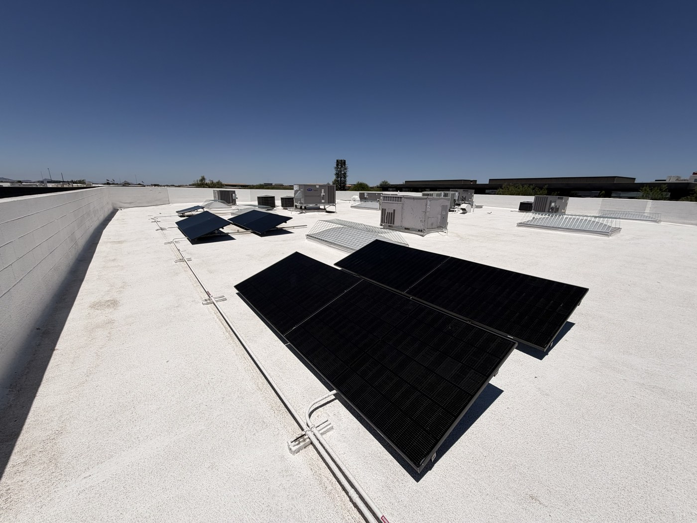 Commercial Solar Installation in Phoenix, AZ Starts With the Roof: What Business Owners Overlook Commercial rooftop solar panels installed on a flat roof for an Arizona business property