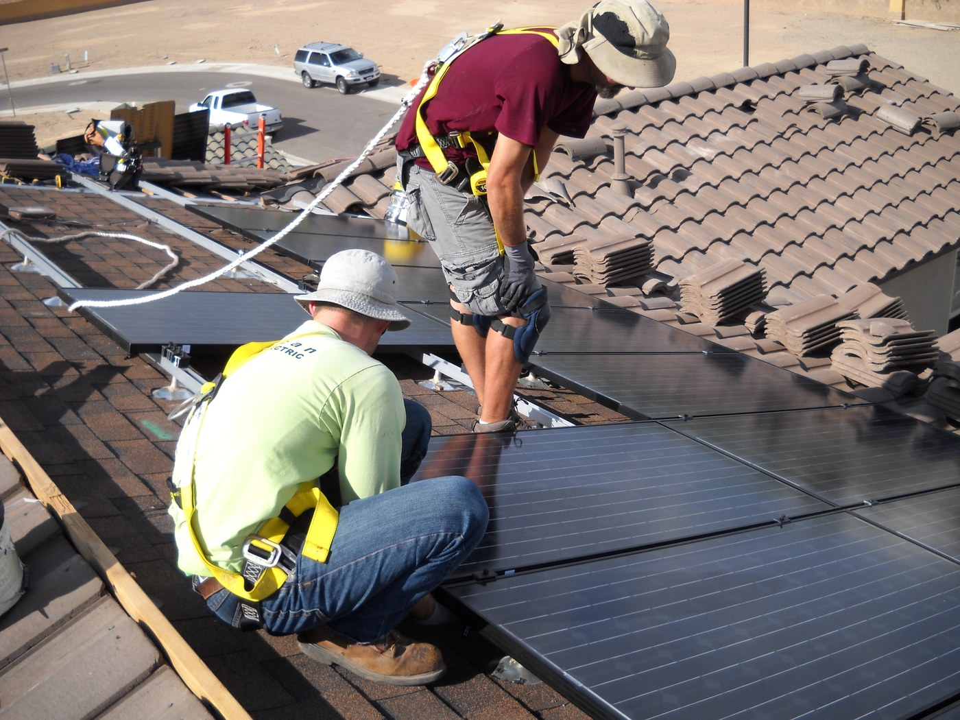Why Roof Penetrations Deserve More Attention in a Solar Roof Installation in Phoenix, AZ Solar installers working on roof mounting hardware where waterproofing protects an Arizona home