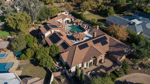 Aerial view of a large Phoenix home with a custom rooftop solar design planned around complex rooflines