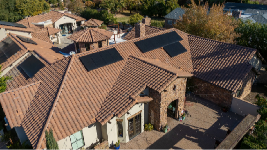 What Makes a Solar Installation Look Clean: The Residential Solar Installers in Phoenix, AZ Behind Premium Design Aerial view of a luxury tile-roof home with solar panels arranged in clean rectangular groups