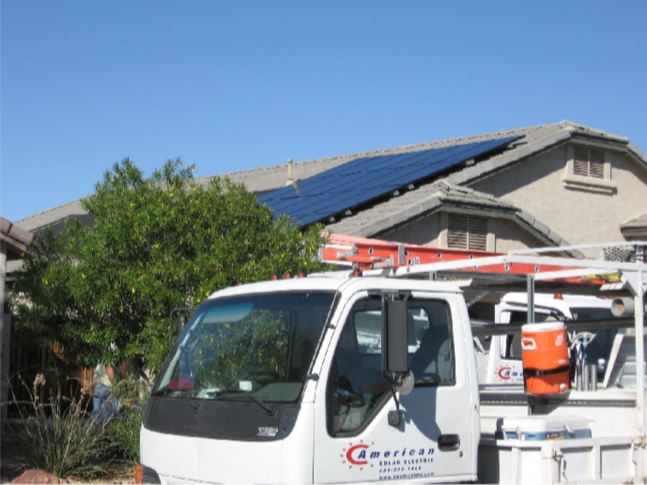 The One-Roof Mindset: Why the Best Solar and Roofing Contractors in Phoenix, AZ Plan Everything Together American Solar and Roofing service truck parked beside a tile-roof home with solar panels