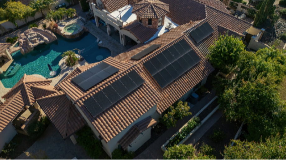 Aerial view of a large Arizona tile roof with solar panels arranged across multiple roof planes for coordinated whole-roof planning
