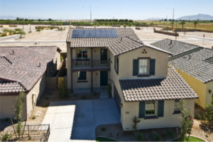 Two-story Gilbert-style home with rooftop solar panels integrated into a tile roof