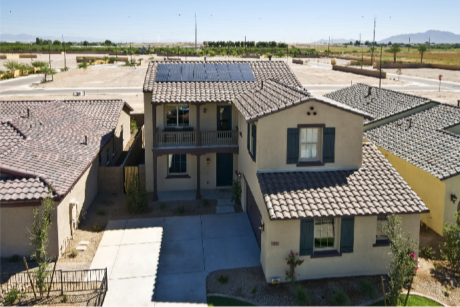 Two-story Gilbert-style home with rooftop solar panels integrated into a tile roof