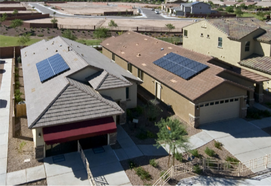 Aerial view of neighboring Arizona homes with solar panels on different roof planes