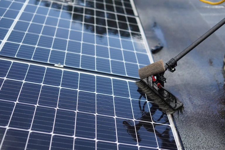 Professional cleaning of solar panels on a residential rooftop to improve solar energy performance in Phoenix