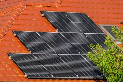 How Energy-Efficient Roofing Reduces Cooling Costs in Hot Climates A residential property’s roof with solar panels